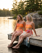 Swimwear with Sunprotective Sarong Coral Sunset, lifestyle seated at water edge